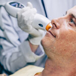 Skin doctor using laser resurfacing facial skincare treatment technology